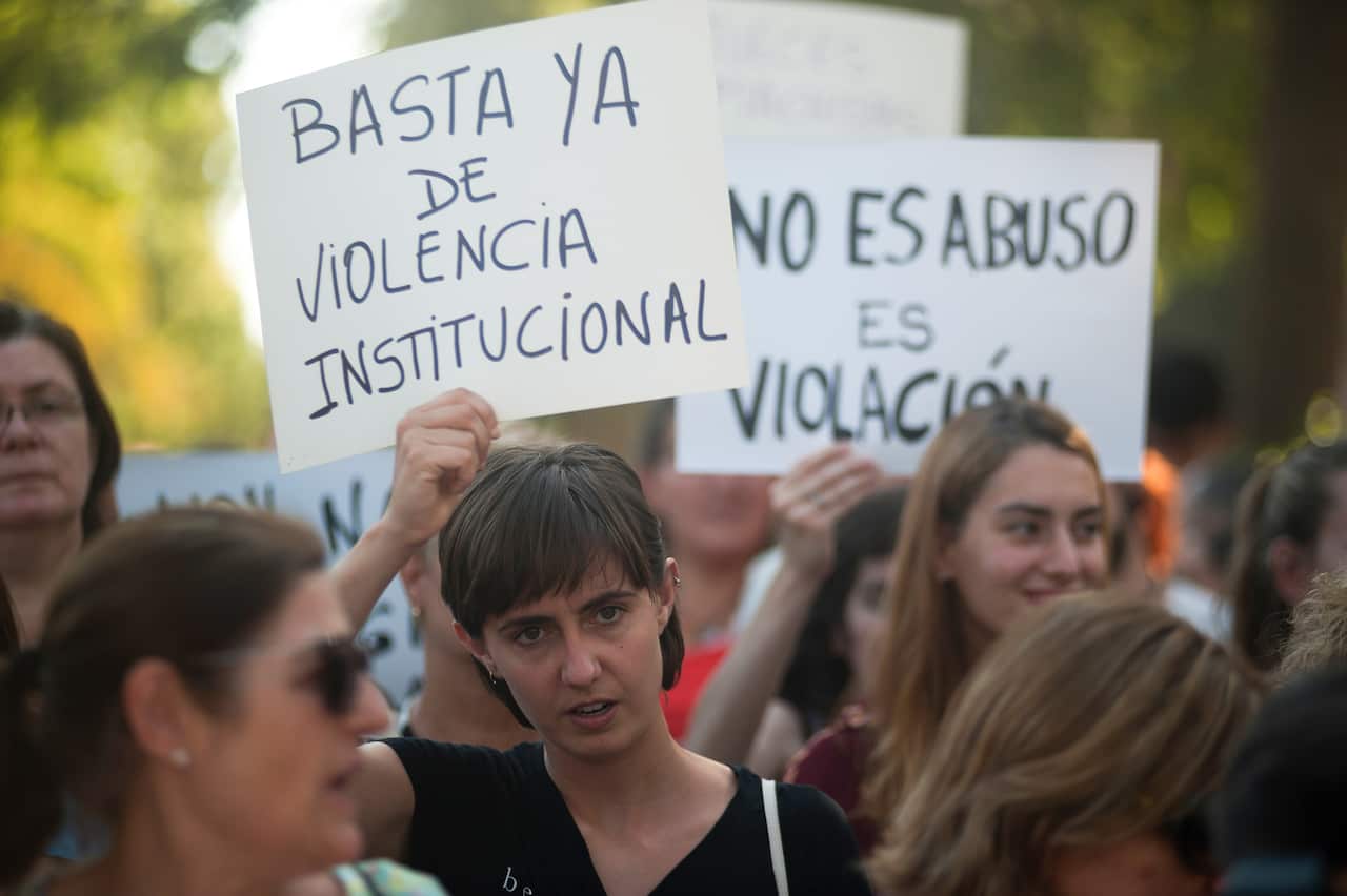 A woman holds a placard during the demonstration in support of a young woman who was raped by seven men in Manresa.