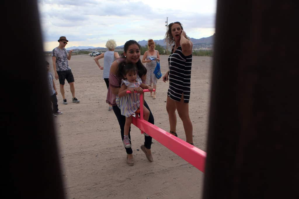 American and Mexican families play with a toy called "up and down" (Seesaw swing) over the Mexican border with US at the Anapra zone in Ciudad Juarez, Chihuahua State, Mexico on July 28, 2019. (Photo by LUIS TORRES / AFP) (Photo credit should read