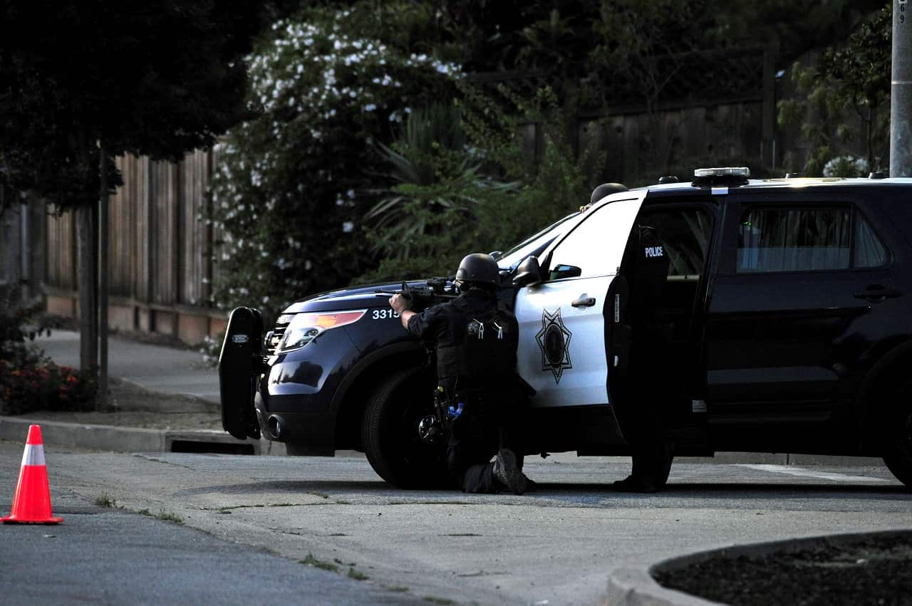 A sniper takes aim on a house where police thought one of the shooters might have been.