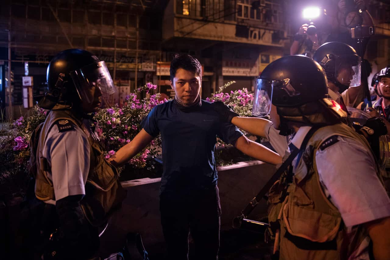 A protester is arrested by riot police officers during demonstrations in Hong Kong.