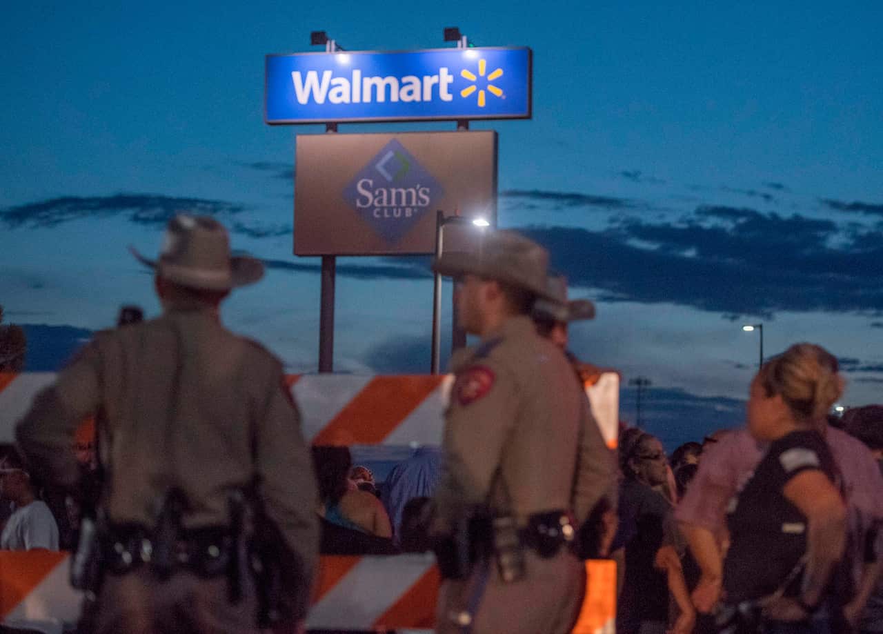 Texas State Troopers keep watch at the makeshift memorial for victims of the shooting that left a total of 22 people dead at the Cielo Vista Mall WalMart.