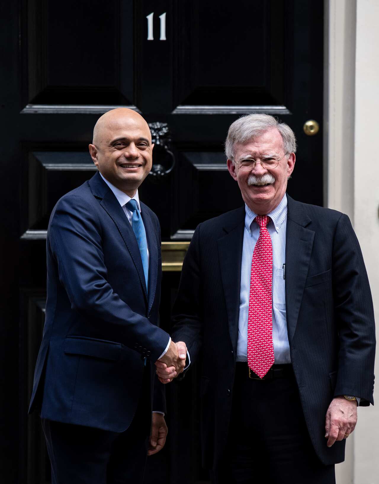 US National Security Adviser, John Bolton (R) is greeted by the Chancellor of the United Kingdom, Sajid Javid, at 11 Downing Street.