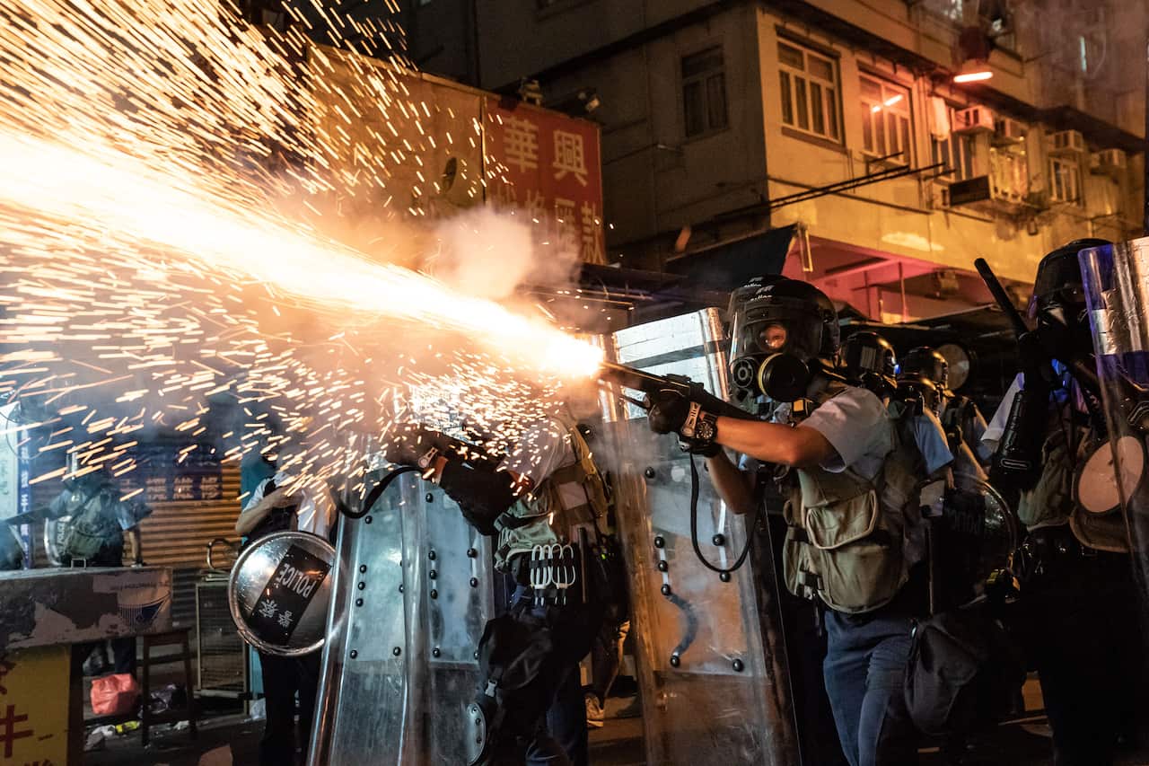 Police fire tear gas to clear pro-Democracy protesters during a demonstration on Hungry Ghost Festival day in the Sham Shui Po district.