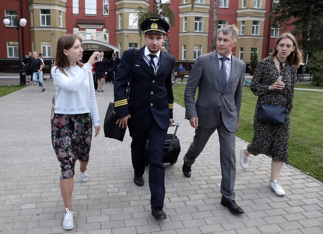Airbus A321 plane co-pilot Georgy Murzin (2nd L), Ural Airlines operational director Alexander Zinovyev (2nd R).