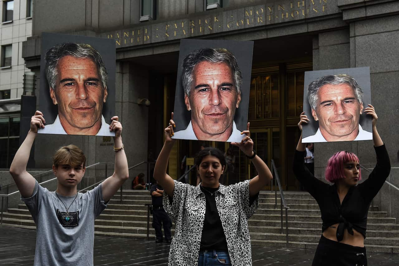 A protest group called "Hot Mess" hold up signs of Jeffrey Epstein in front of the Federal courthouse in New York City. 