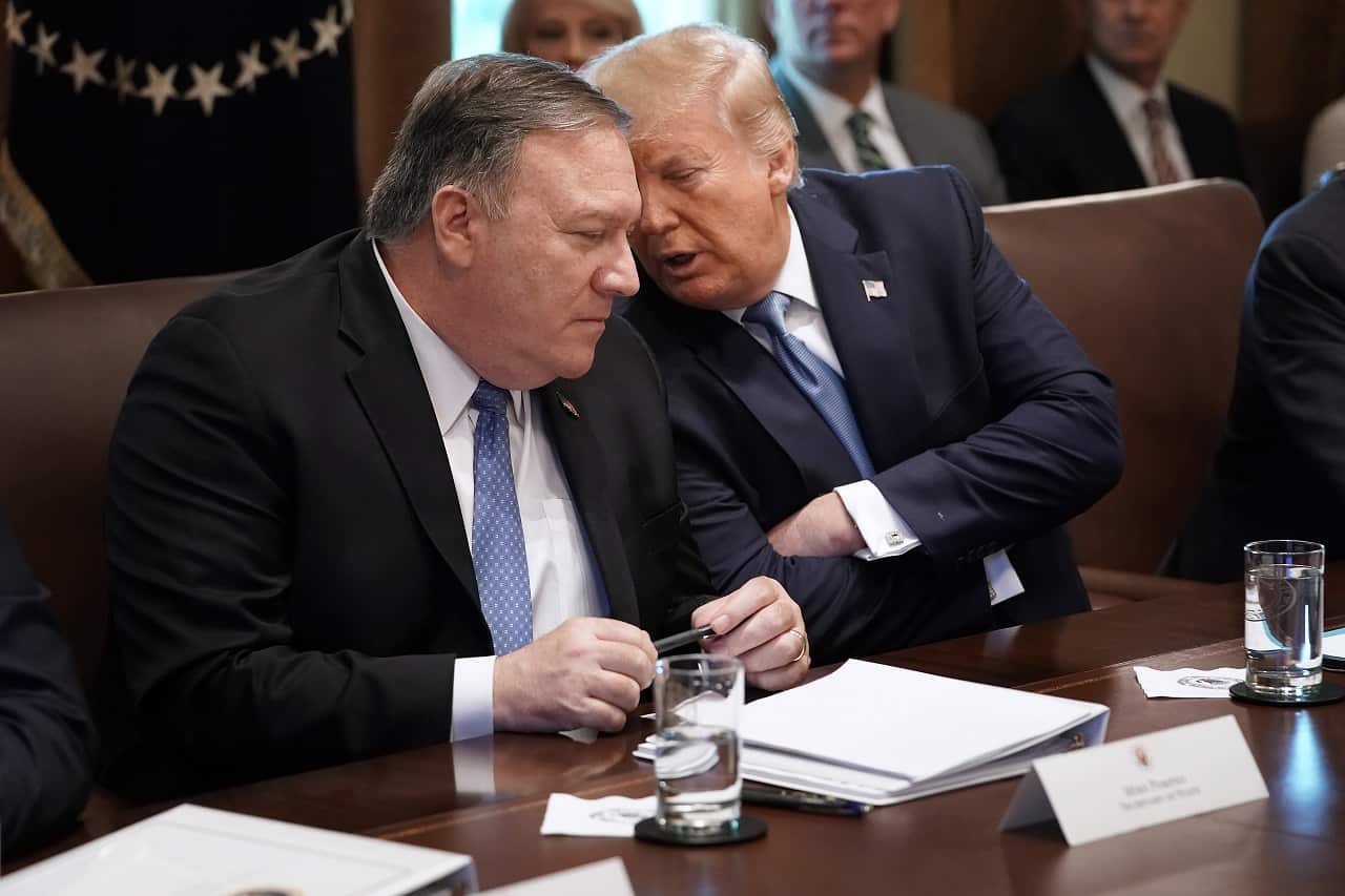 President Donald Trump talks with Secretary of State Mike Pompeo.