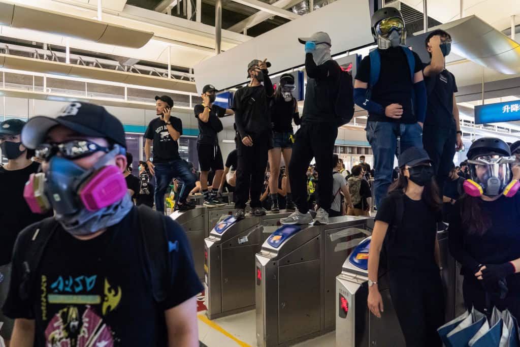 Protestors stand off against riot police during a protest at the Yuen Long MTR station 