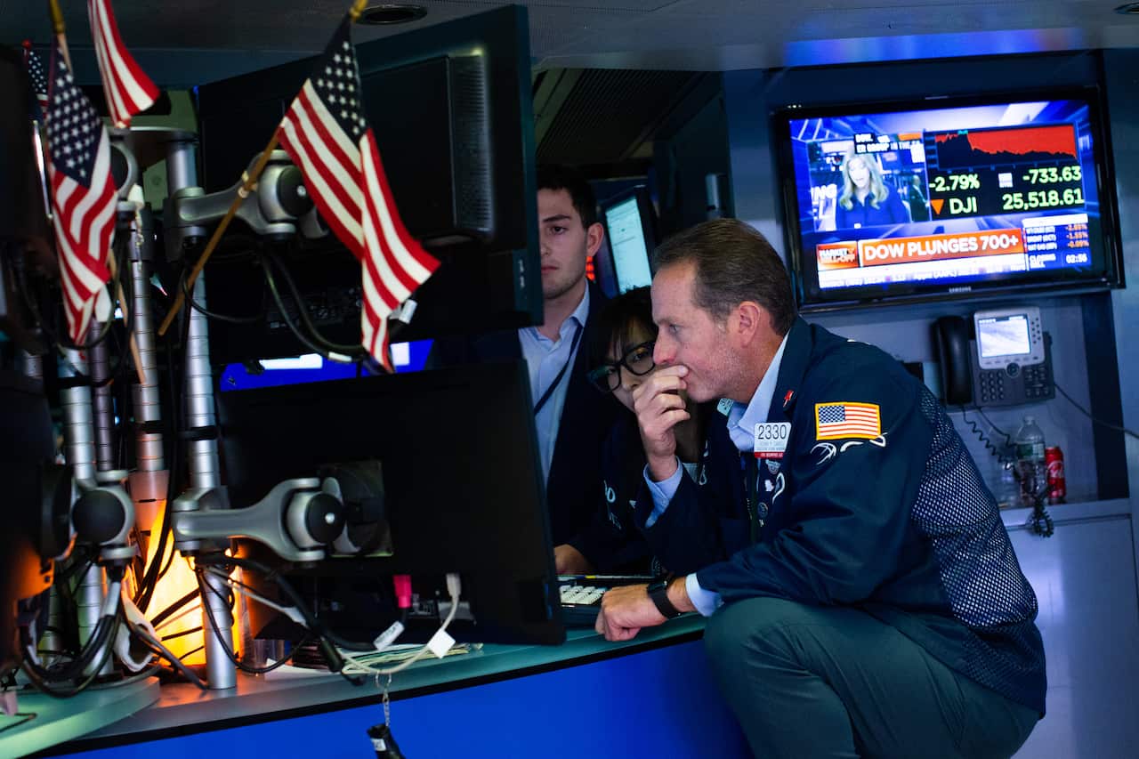 Traders work on the floor of the New York Stock Exchange.