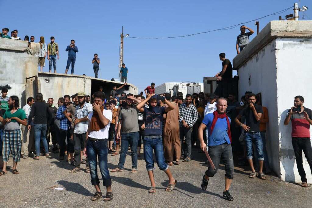 Displaced Syrians demonstrate along the border with Turkey near the town of Atme in the northwestern Idlib province.
