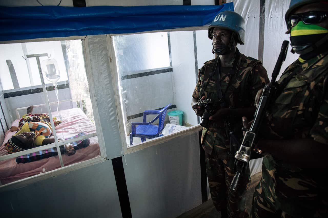 United Nations peacekeepers stand next to a patient during a visit of the UN secretary-general at an Ebola treatment centre in Mangina on 1 September, 2019. 