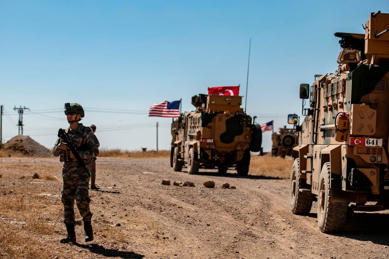 A US soldier stands guard during a joint patrol with Turkish troops in the Syrian village of al-Hashisha along the border with Turkish troops, on September 8.