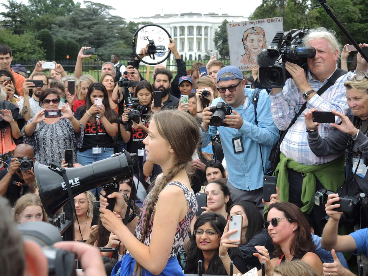 Swedish environmental activist Greta Thunberg (M) speaks with a megaphone during a school strike for more climate protection in front of the White House.