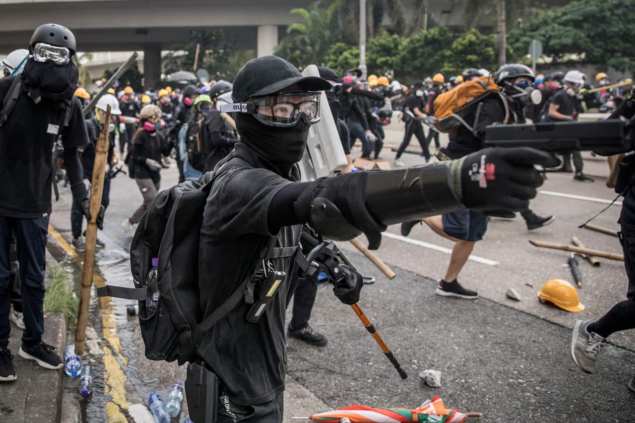 A protester fires a BB gun during clashes with police after a rally in Kwun Tong on August 24, 2019 in Hong Kong, China
