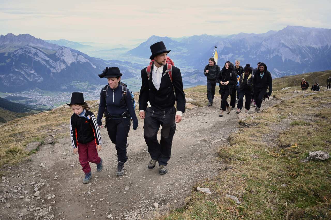 People take part in a ceremony to mark the 'death' of the Pizol glacier.