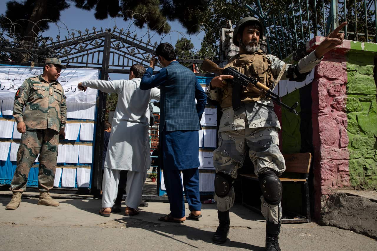 Afghan security watches the streets outside a polling station in a key residential election in Kabul.
