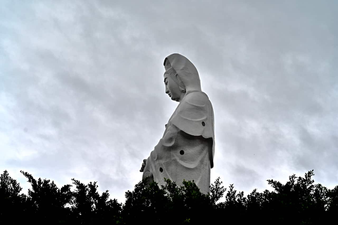 A statue of Matsu is seen at Zhongzheng Park in Keelung city as Typhoon Mitag approaches the northeast coast of Taiwan.