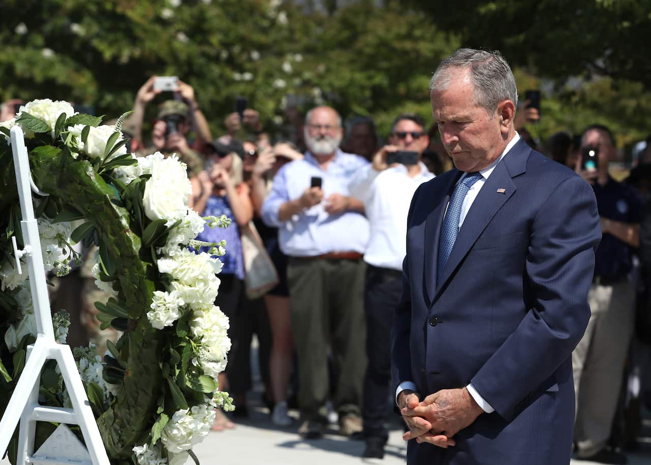 Former U.S. President George W. Bush participates in a wreath-laying ceremony at the 9/11 Pentagon Memorial.