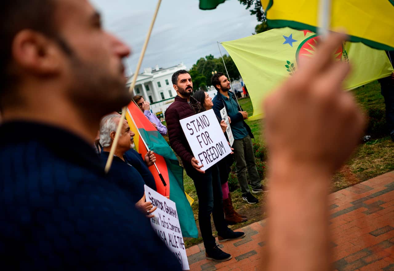 Protesters demonstrate against US President Donald Trump's decision to withdraw US troops from northeastern Syria in front of the White House.
