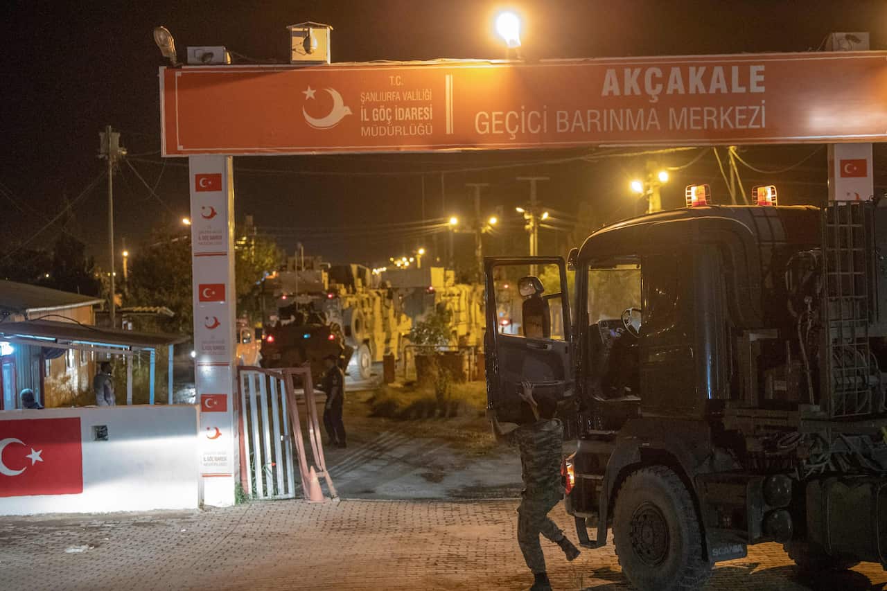 Turkish army soldiers drive towards the border with Syria near Akcakale in Sanliurfa province.