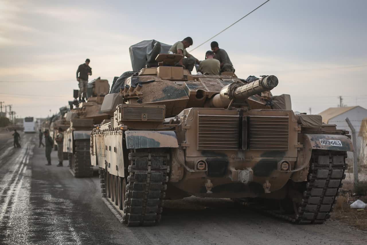 Military vehicles are deployed at a staging area for the Turkish Armed Forces along the border with the Syrian town of Tall Abyad.