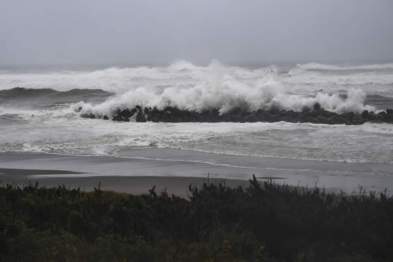 Strong waves hit a seawall along the coast in Hamamatsu.