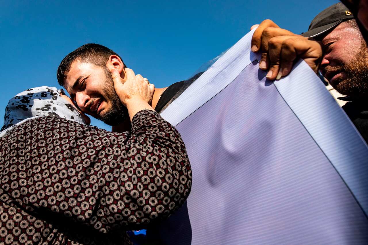 Mourners attend a funeral for Kurdish political leader Hevrin Khalaf and others in the northeastern Syrian Kurdish town of Derik.