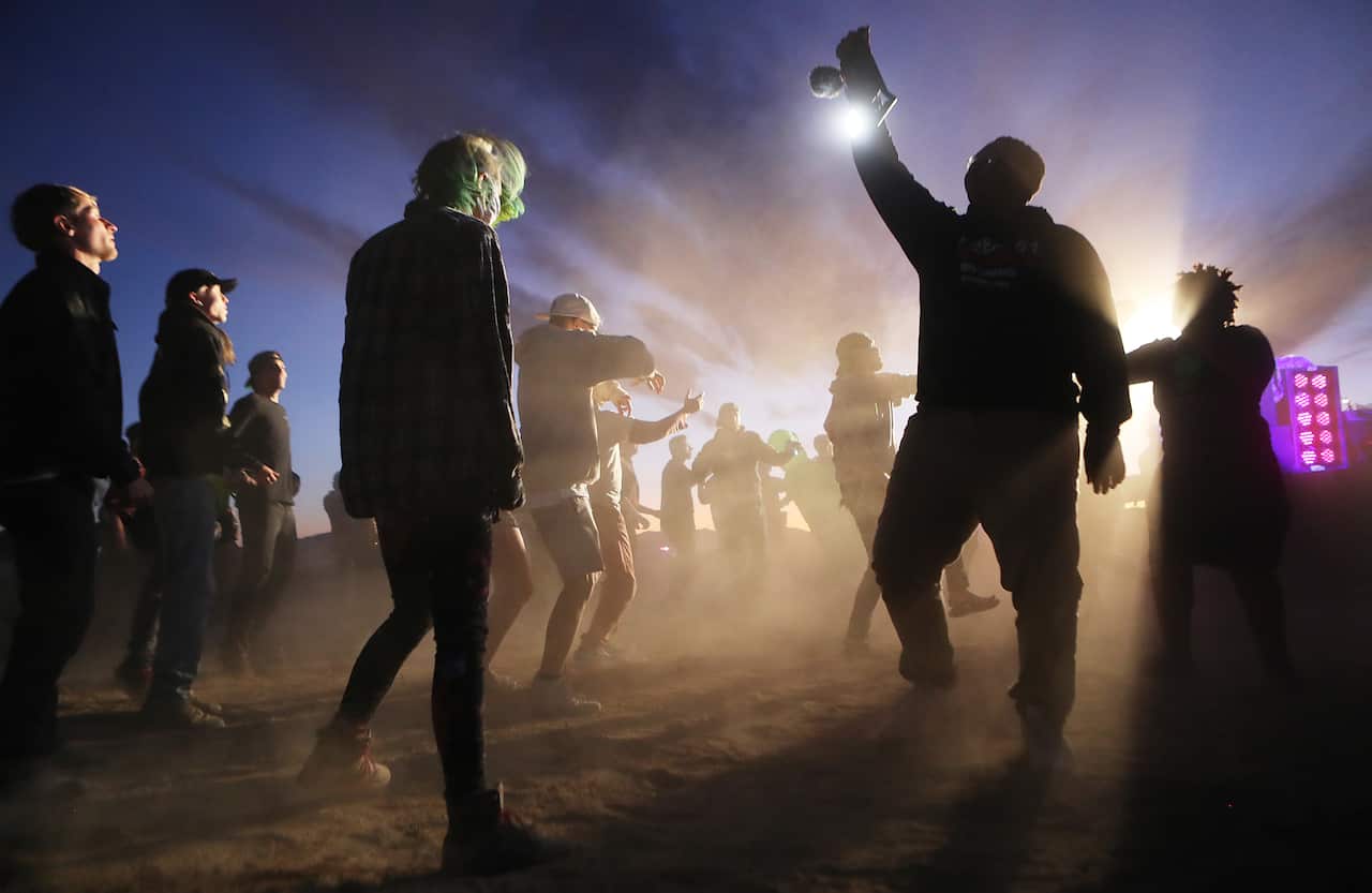 Revelers dance at the 'Storm Area 51' spinoff event 'Alienstock' in Rachel, Nevada.