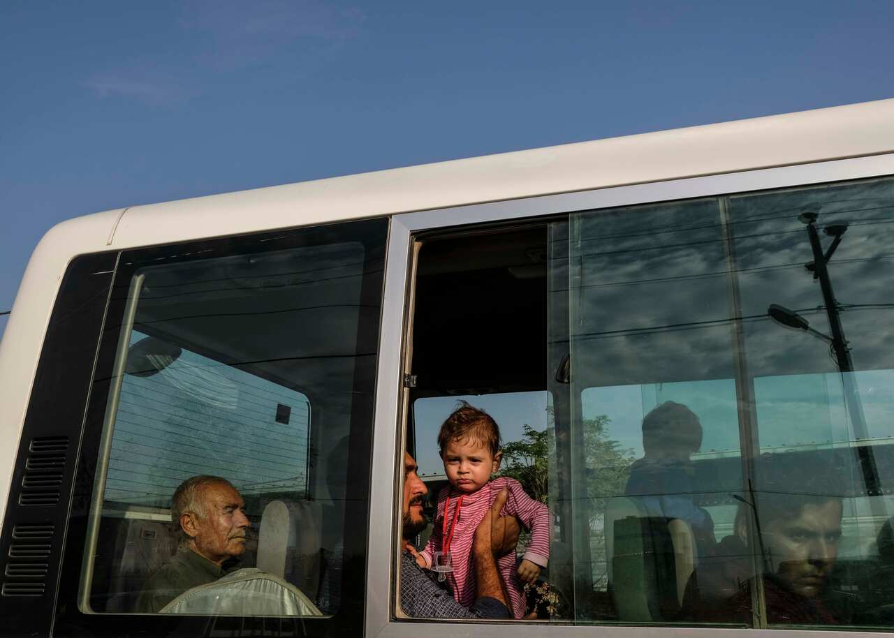 A man from the Syrian town of Qamishli with his seven month year-old daughter flee the Turkish incursion.