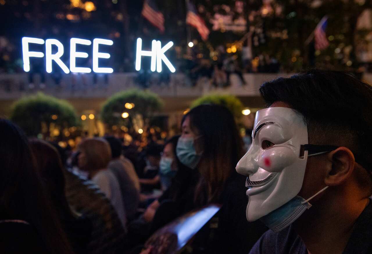 A pro-democracy supporter wearing a Guy Fawkes mask during an assembly of medical professionals in Central district in Hong Kong.