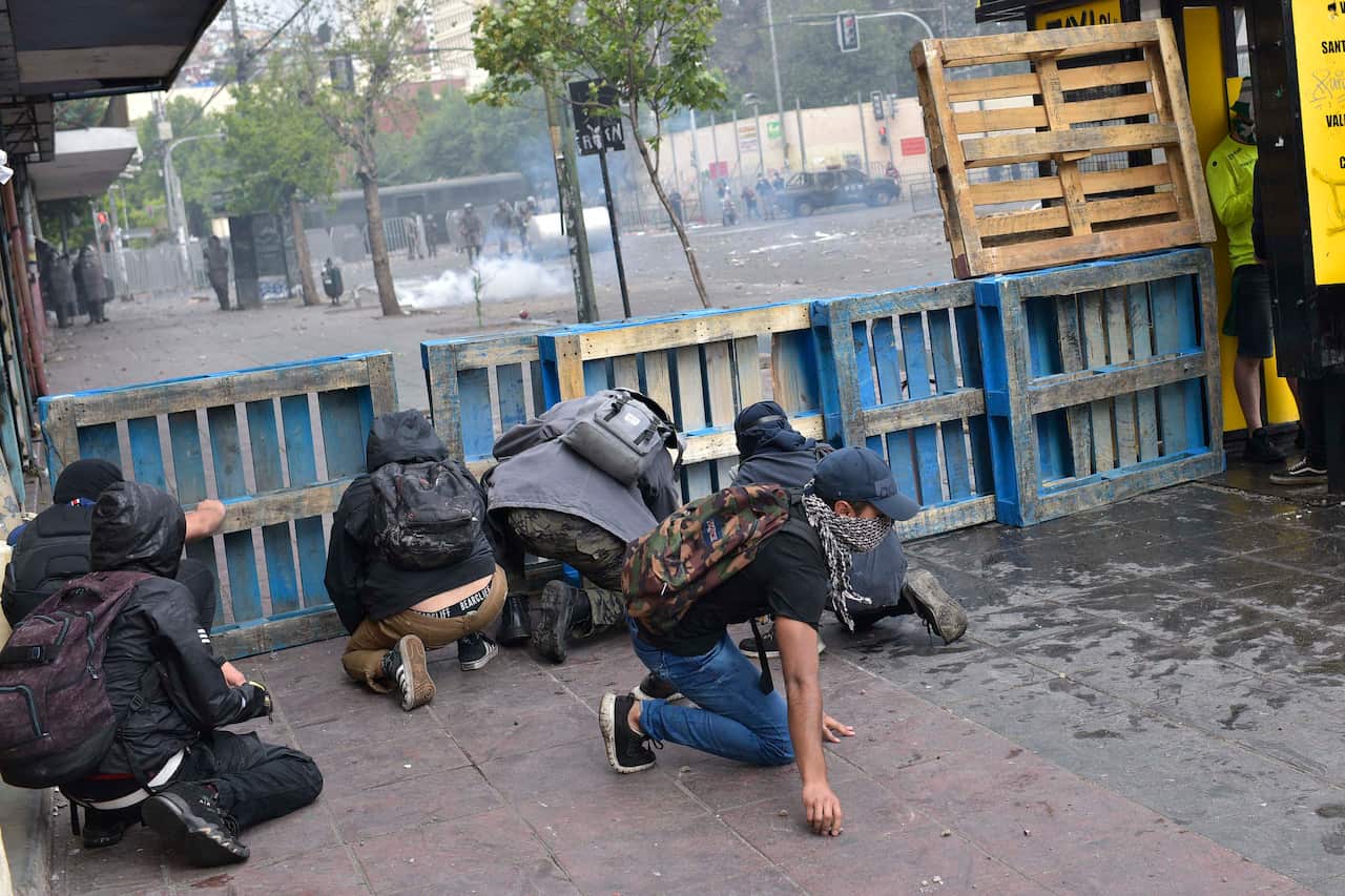 Demonstrators clash with security forces during a demonstration in Valparaiso, Chile.