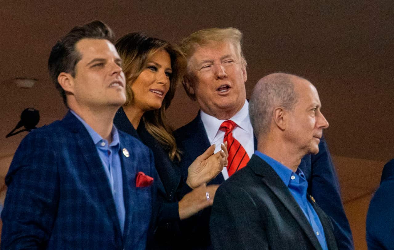 US President Donald Trump speaks with US First Lady Melania Trump as they attend Game 5 of the World Series,