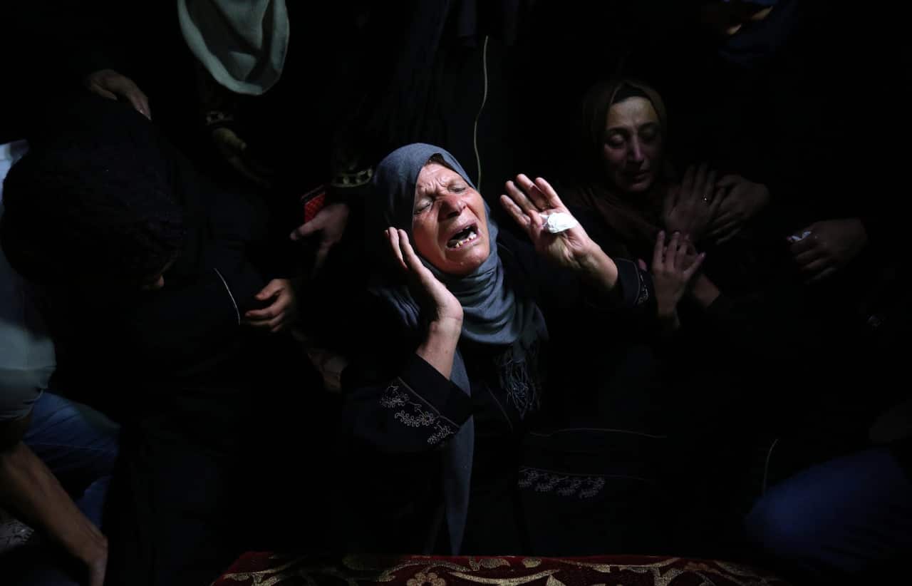 Relatives of Ahmed al-Shehri, 27, mourn over his body at the family house during his funeral in the town of Khan Younis, southern Gaza Strip.
