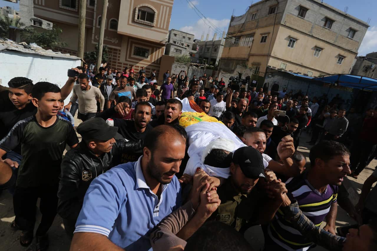 Mourners carry the body of Ahmed al-Shehri, 27, during his funeral in the town of Khan Younis, southern Gaza Strip.