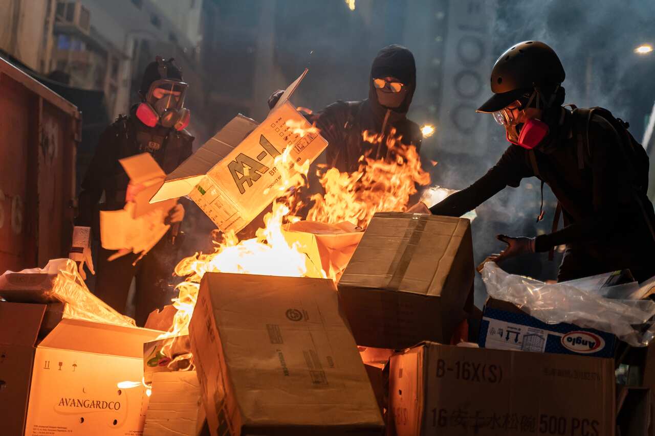 Pro-democracy protesters set a barricade on fire during a demonstration in Causeway Bay district.