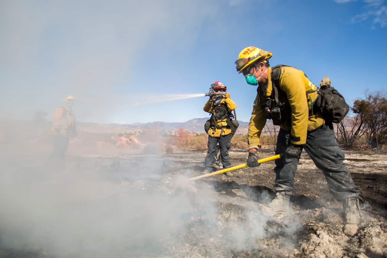 Firefighters from Santa Fe Springs battle to control hotspots of the Maria Fire, in Santa Paula, Ventura County, California.