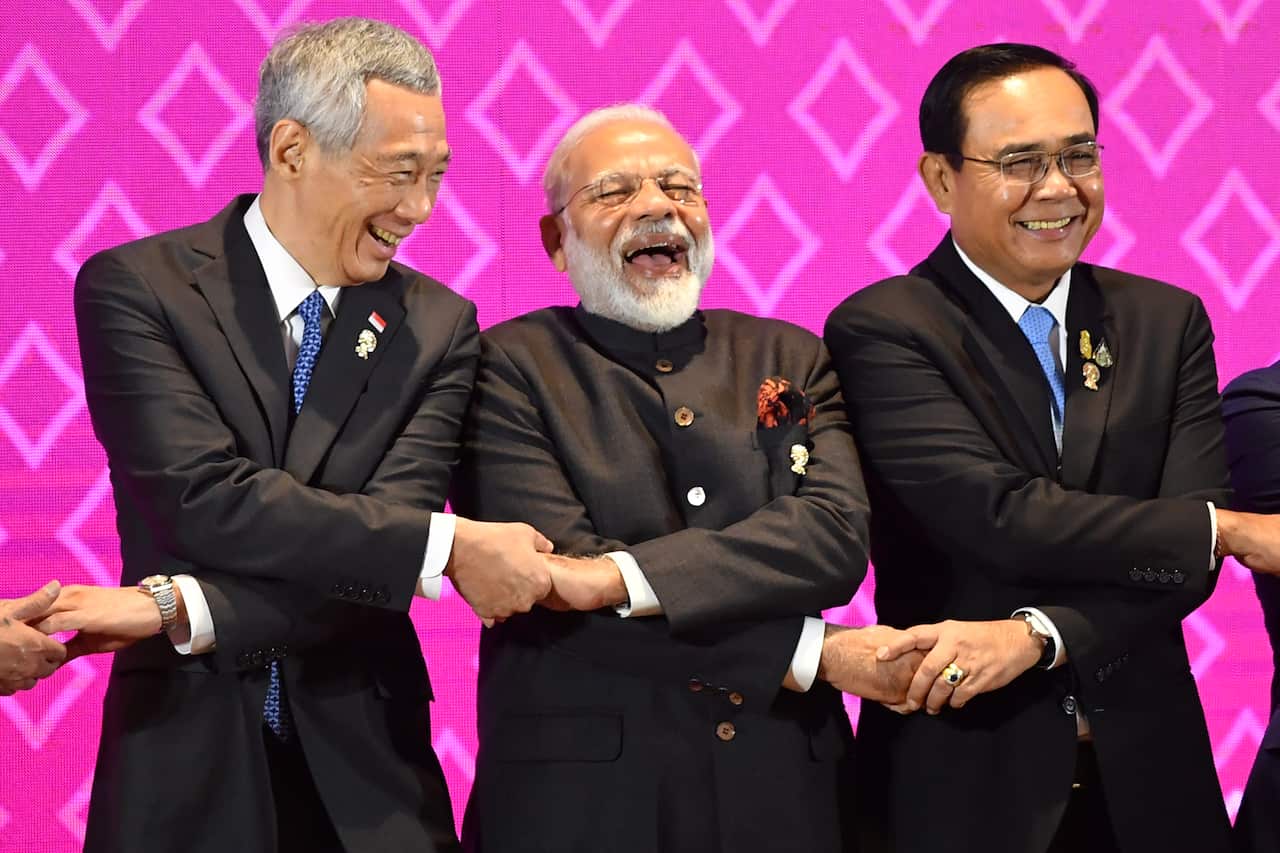 Singapore's Prime Minister Lee Hsien Loong (L) and India's Prime Minister Narendra Modi (C) laugh beside Thailand's  Prime Minister Prayut Chan-O-Cha.