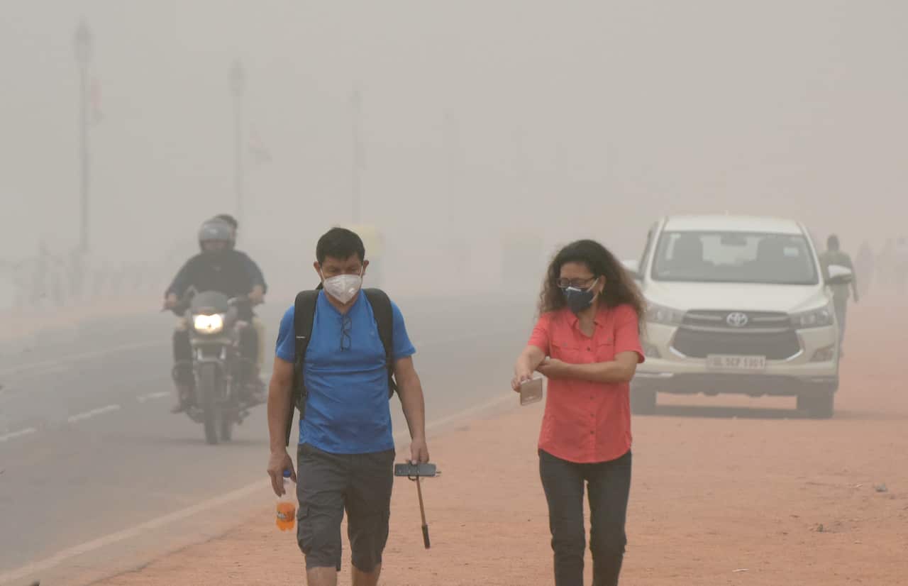 Pollution Maintains Tourists seen wearing mask to protect themselves from smog, at Rajpath, on November 3, 2019 in New Delhi, India.On Delhi-NCR As Air Quality Breaches Index In Some Areas