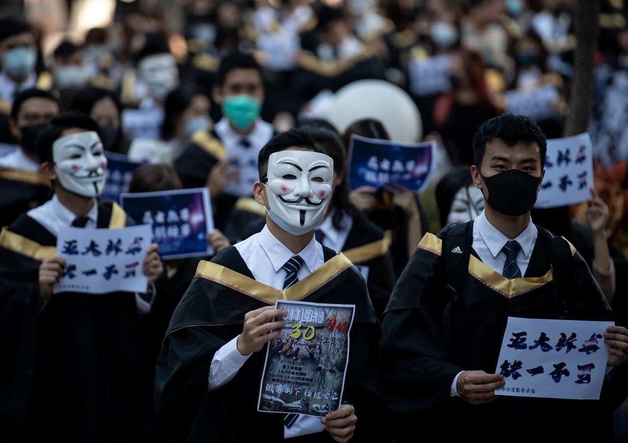 Students wear Guy Fawkes masks, popularised by the 'V For Vendetta' comic book film, before their graduation ceremony at the Hong Kong Polytechnic University.