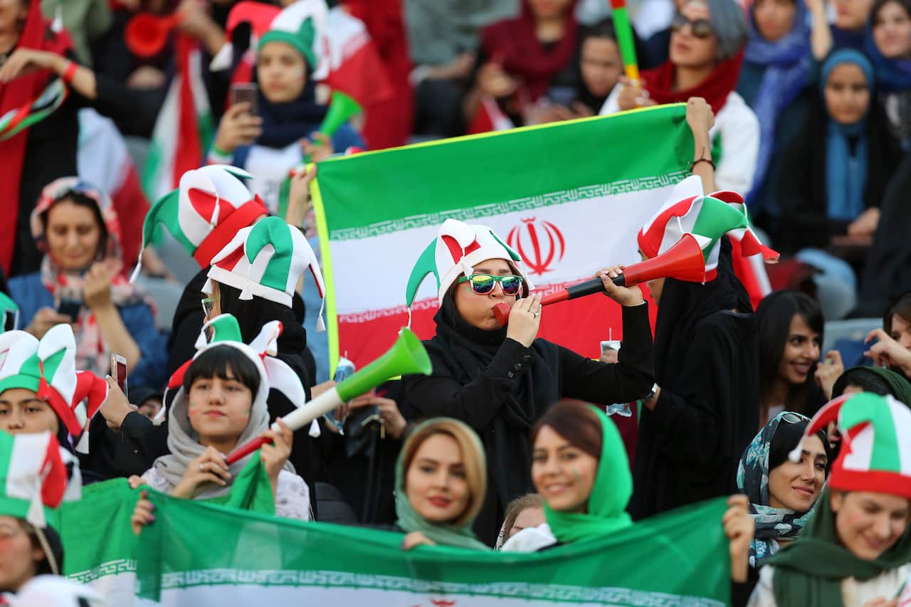 Female football fans show their support ahead of the FIFA World Cup Qualifier match between Iran and Cambodia.