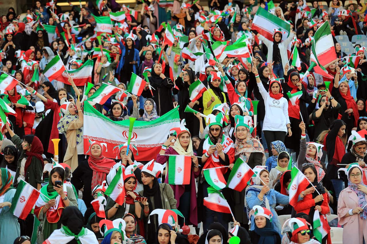 Female football fans show their support ahead of the FIFA World Cup Qualifier match between Iran and Cambodia.