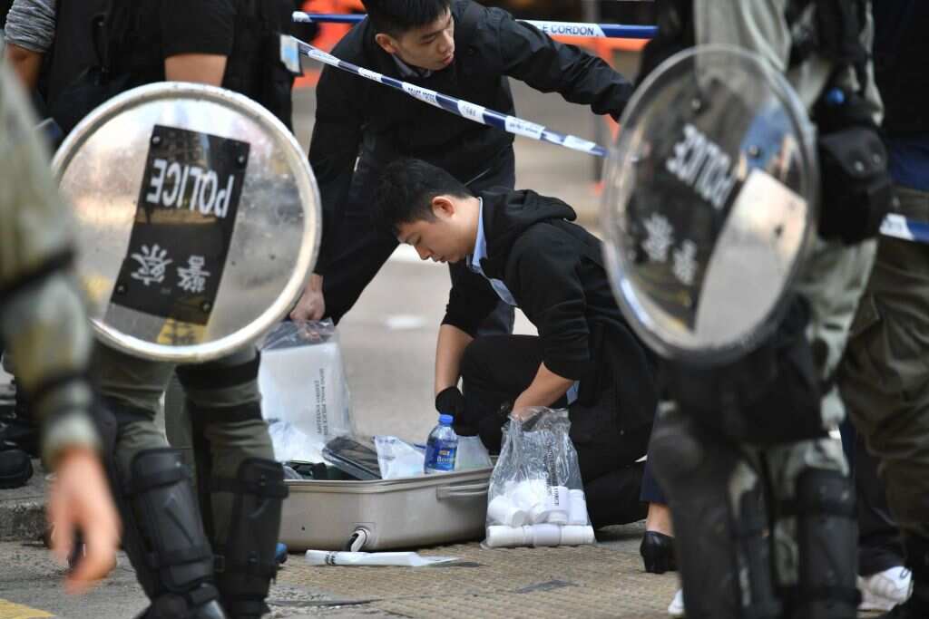 Police officers collect evidence at the site where pro-democracy protesters were shot by a policeman in Hong Kong on 11 November, 2019.