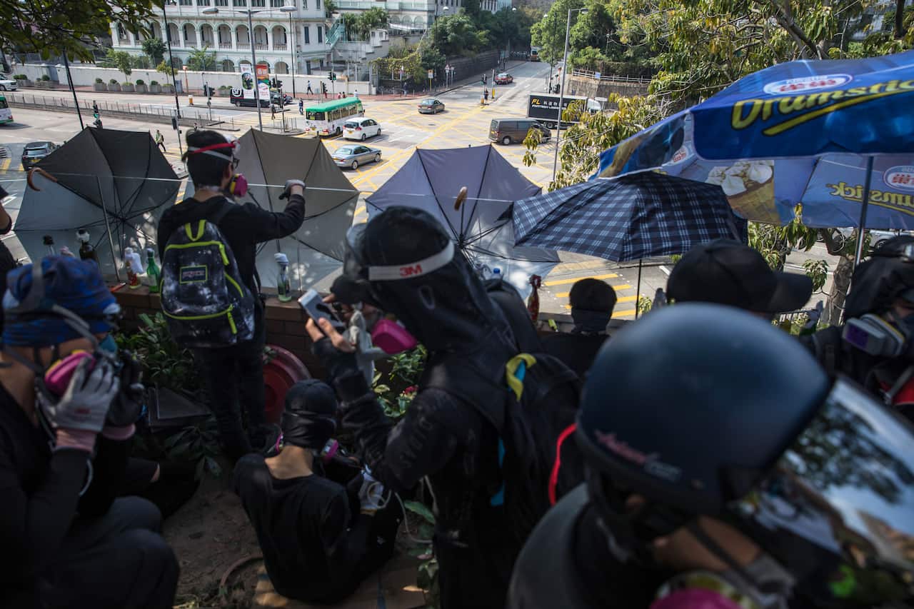 Protesters keep an eye on riot police at The Hong Kong Polytechnic University.