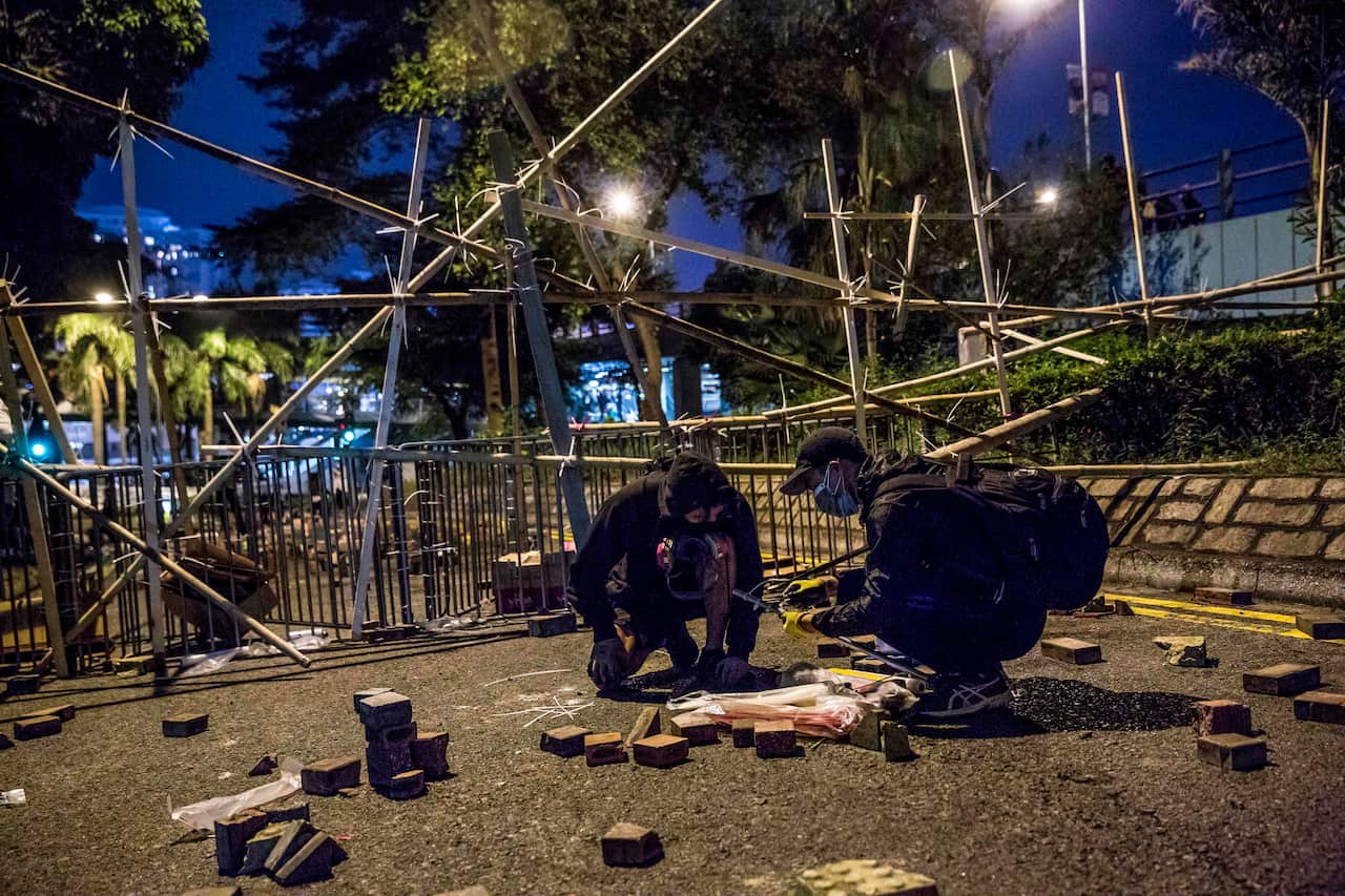 Protesters gather materials to build barricades during a demonstration.