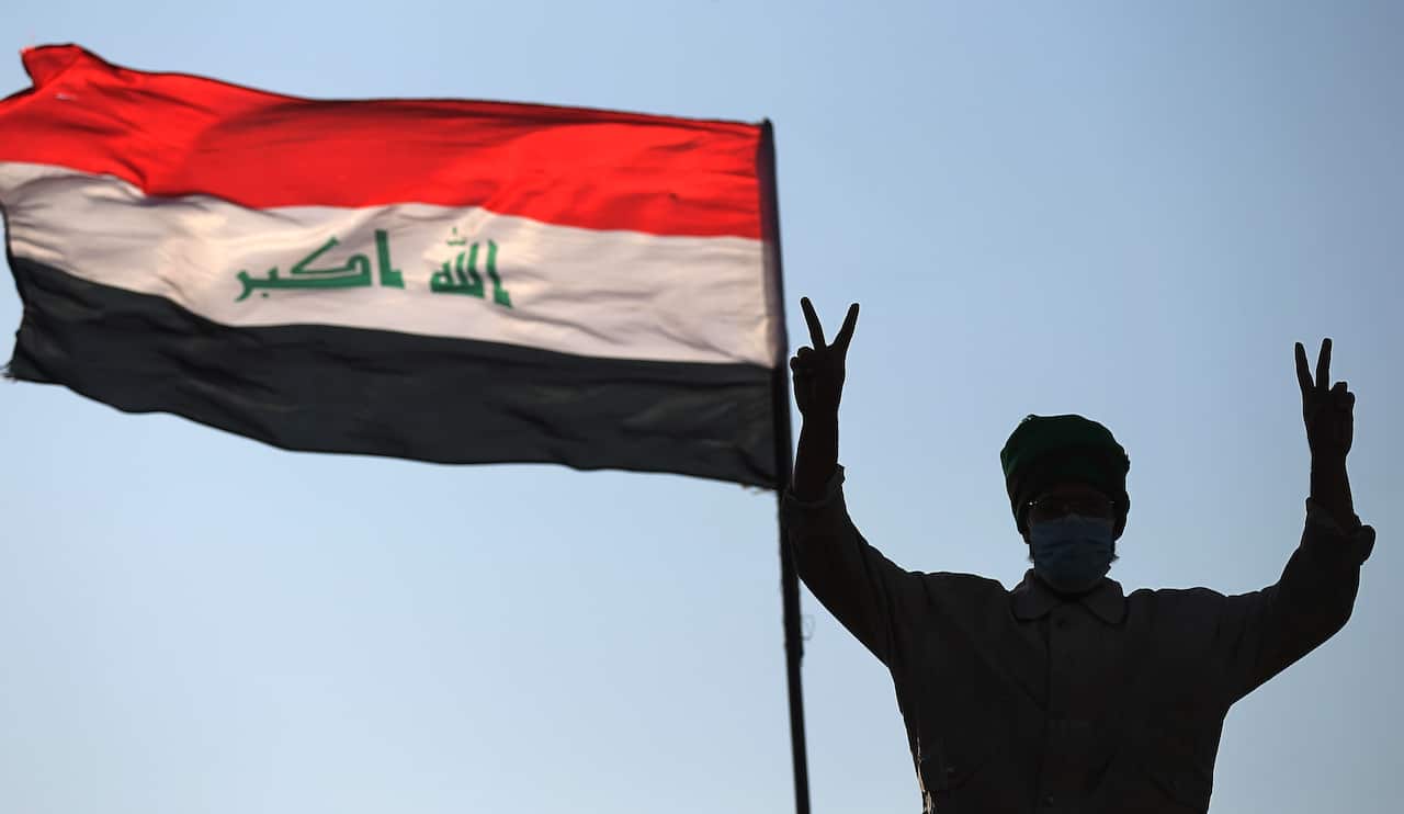 An Iraqi protester flashes the victory sign as he takes part in ongoing anti-government demonstrations.