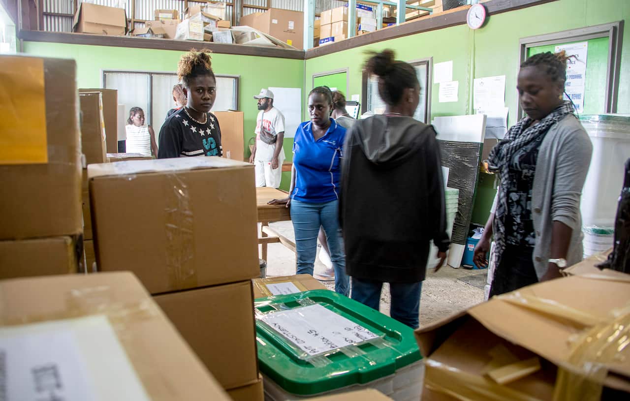 Workers prepare a polling station ahead of the historic independence vote.