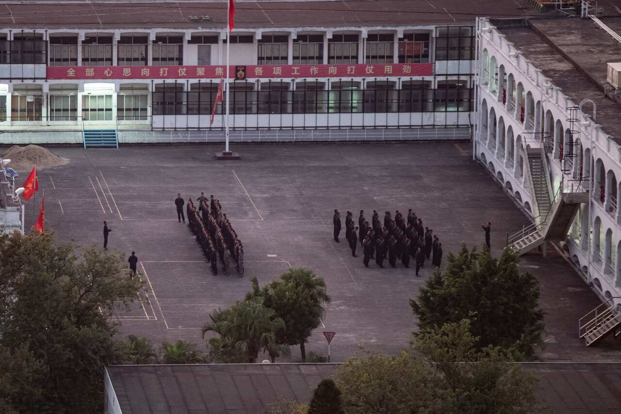 People's Liberation Army (PLA) Hong Kong Garrison soldiers march on the grounds of the Gun Club Hill Barracks located near the Hong Kong Polytechnic University.