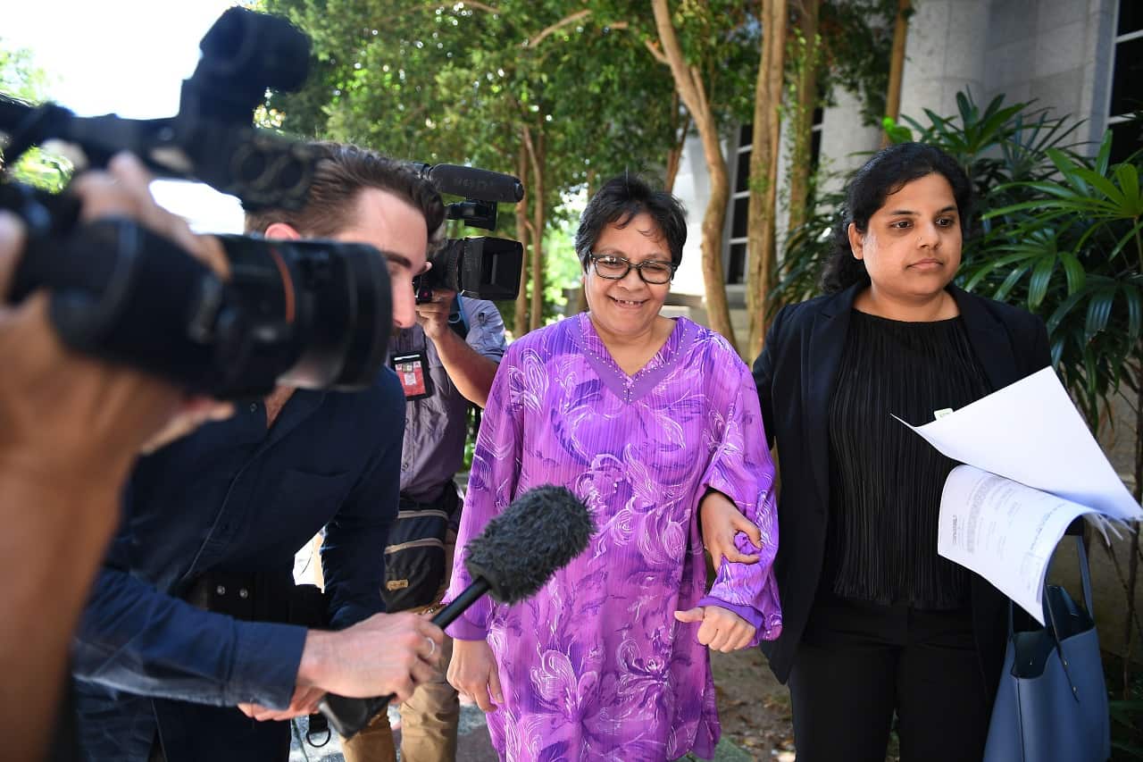 Maria Elvira Pinto Exposto leaves the courthouse on Tuesday.