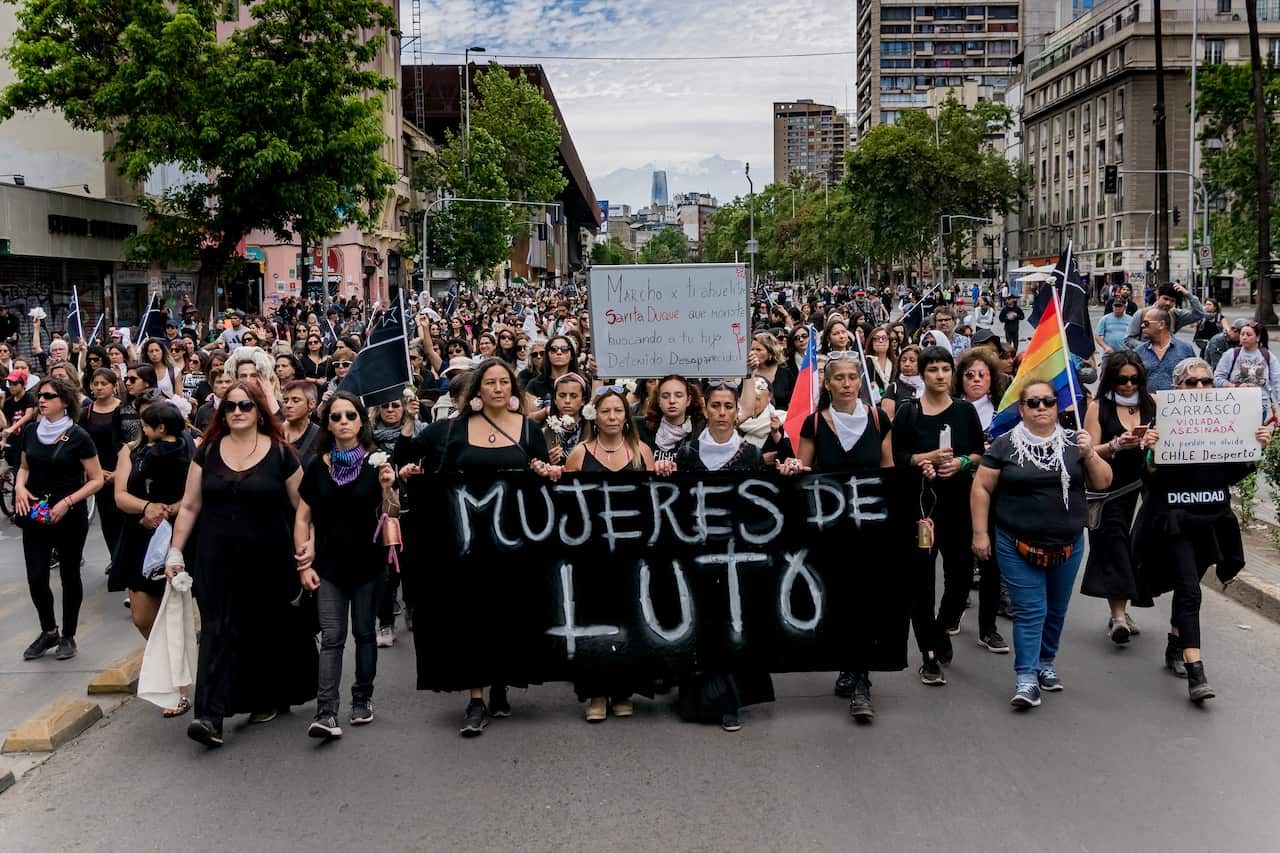 With a sign that says "Women in mourning," hundreds of women walked dressed in black during a silent protest against the government.