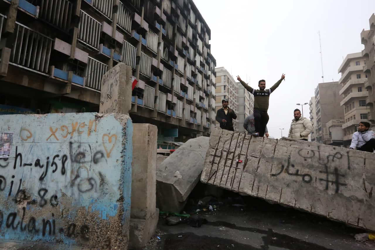 An Iraqi protester gestures as he stands on a cement block at Al-Khilani square in the capital Baghdad.
