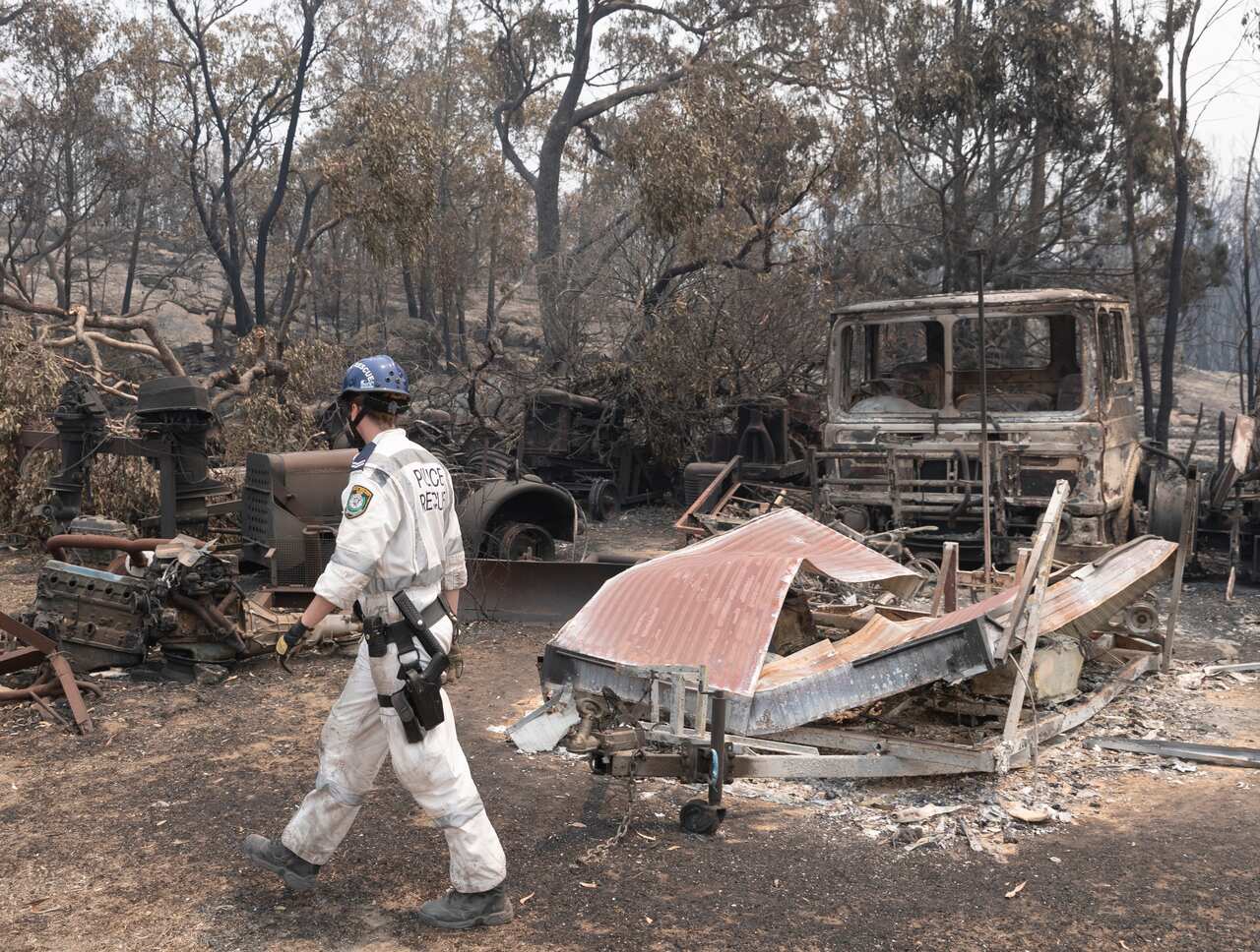 A police officer surveys the damage in NSW last week.